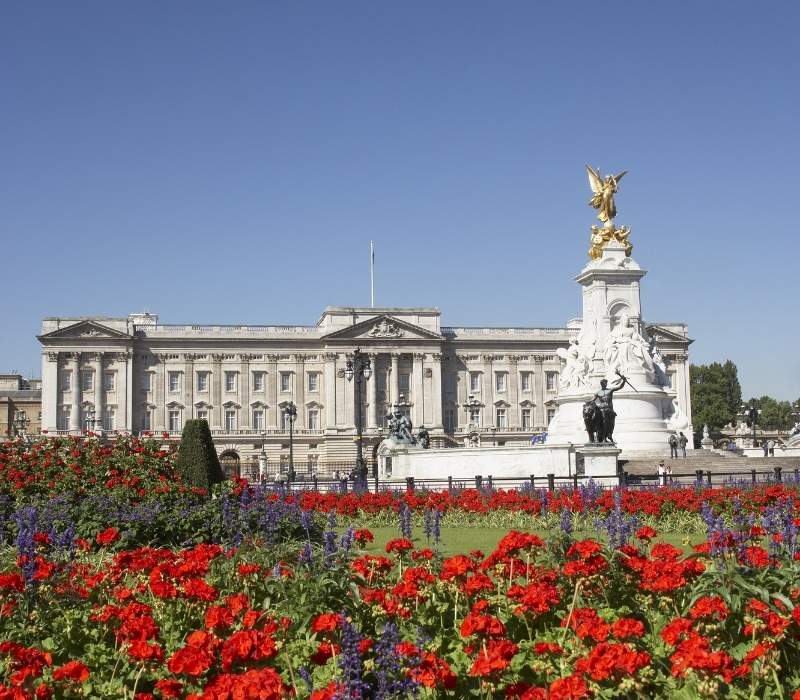 Buckingham Palace with blooming flowers in Queen’s Gardens, London, UK