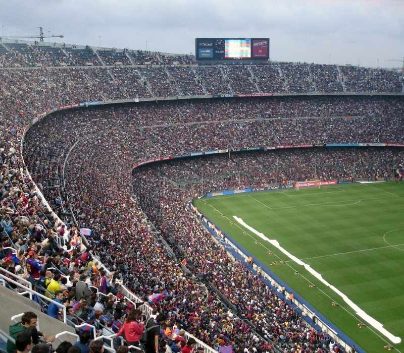 Packed football stadium with cheering supporters and vibrant matchday atmosphere