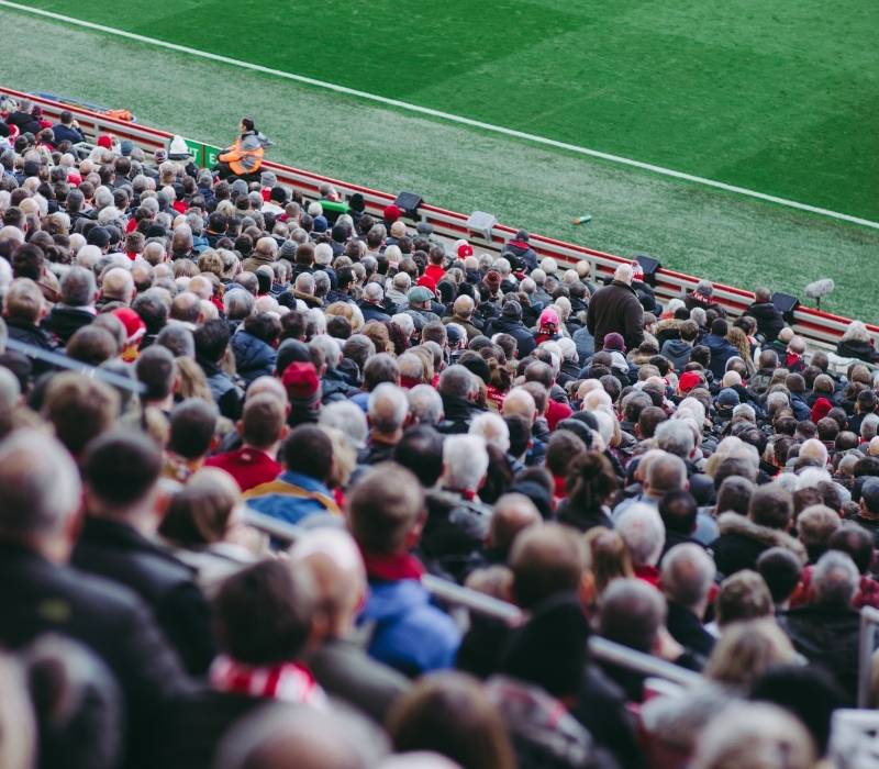 Soccer fans cheering inside a packed football stadium during a match